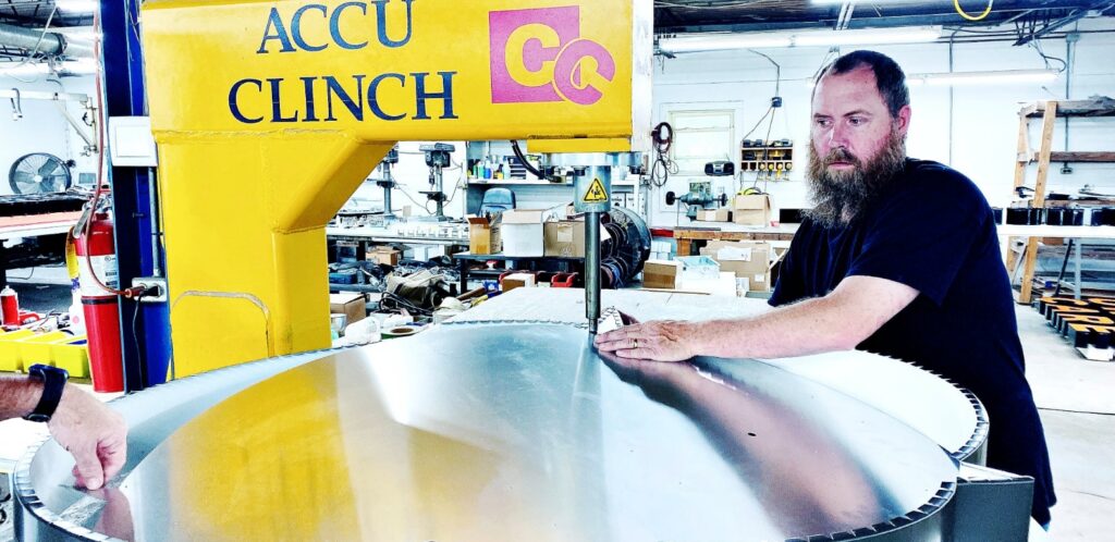 Signage industries employee constructing a sign.